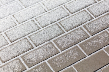 Fototapeta premium A brick wall covered in snow