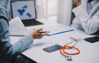 Meeting, tablet and team of doctors with collaboration for healthcare talk and telehealth app in office. Surgeon group, tech and medical discussion with website for hospital funding or sponsorship