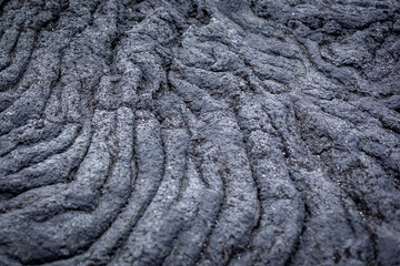 Fototapeta premium Gray layers of lava rock as background. Hvaleyri beach, Iceland. 