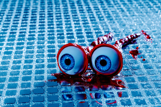 Fake eyeballs with red optic nerves and blood on mirrors for halloween prank