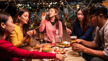 Group of Asians are having a celebration at a restaurant with drinks.	