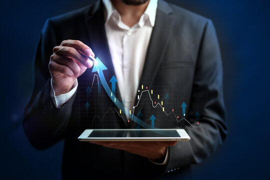 Business professional analyzing data trends on a digital tablet in a modern setting