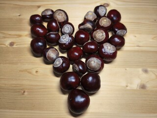 Chestnuts Arranged in Heart Shape on Wooden Table