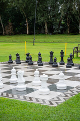a giant outdoor chess board on a well maintained lawn