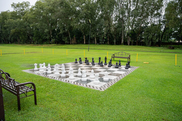 a giant outdoor chess board on a well maintained lawn