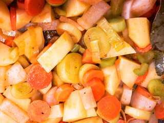 Top view of chopped fresh vegetables frying on a pan. Close up view of delicious and healthy vegetables seasoned.