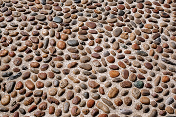 Close-up Background Texture of Historic Italian River Cobblestone Pavement (Ciottoli) Set in...