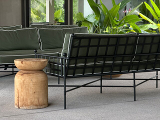 Modern Outdoor Lounge with Green Cushions and Wooden Stool