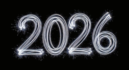 Sparkling silver numbers 2026 illuminating the dark background with shimmering particles and bright light effects