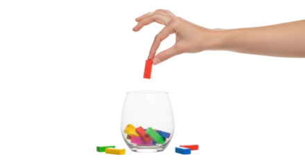 Isolated hand dropping colorful blocks into a glass with cubes for drawing lots game toy