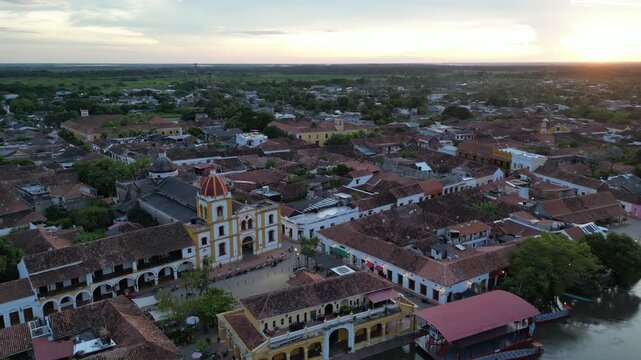 Aerial view of Santa Cruz de Mompox (Momp&oacute;s) on the banks of the Magdalena River in the Bol&iacute;var Department in Colombia, showing Plaza Real De La Concepci&oacute;n and Inmaculada Concepci&oacute;n church at sunset