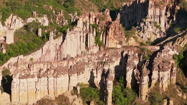 Aerial tilt down view of the stunning rock formations and eroded columns in los estoraques, colombia