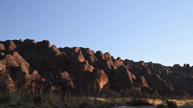 sunset over Purnululu National Park, World Heritage Site in the kimberley region of Western Australia, a popular travel destination famous for its layered rock formations, of the Bungle Bungle Range.