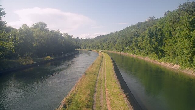 Cycle pedestrian path along one of the canals that originate from the Ticino river. Canale Villoresi (Villoresi canal) near Somma Lombardo town, Maddalena hamlet, Italy