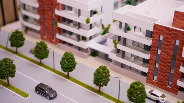 Realistic architectural scale model portraying  modern residential area featuring apartment complexes, roads, tiny vehicles, and lush parks, highlighting urban design and property development