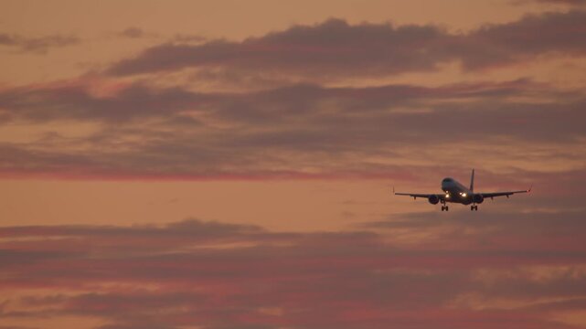 Airplane landing at sunset 4k video