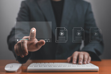 Businessman touching virtual video player interface on digital screen, representing online media, e-learning, streaming technology, and digital content innovation for modern communication.