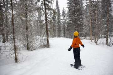 young woman Snowshoeing in winter