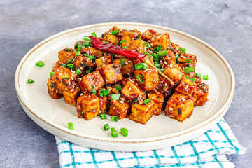 Stir-Fried Tofu in Soy Garlic Sauce, Vegan High-Protein Food Close-Up Photo, Healthy Eating Concept
