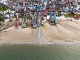 Obraz premium Aerial drone view of coastal sewage and wastewater flowing from seaside restaurants into the ocean showing environmental pollution