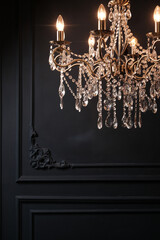 Classic crystal chandelier on a dark wall. The blue wall. Crystal, details.