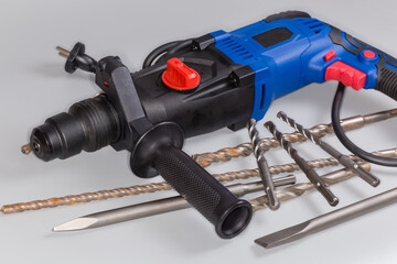 Electric rotary hammer and different drill bits, fragment close-up