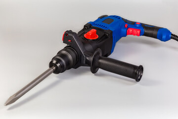 Electric rotary hammer drill with inserted pointed chisel close-up