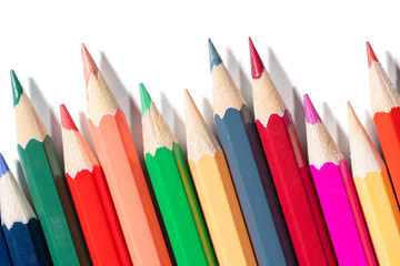 Fototapeta premium Macro shot of vivid colored pencils on transparent background with shadows. Artistic supplies for design, drawing and creativity projects.