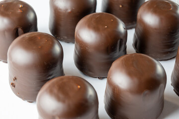 Chocolate-Covered Marshmallow Candy on White Background