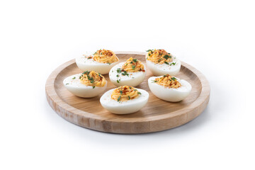 Homemade hard Boiled Deviled Eggs garnished with herbs isolated on white background