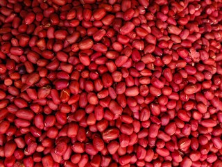 Raw red peanuts close-up background