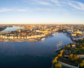 Aerial view of Gamla Stan's medieval architecture and the Skeppsholmen's sailing ship glisten under the soft light of dawn, Stockholm, Stockholm County, Sweden.