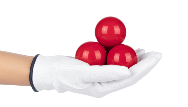 Glossy red spheres stacked on a white gloved hand isolated on solid white background in Png
