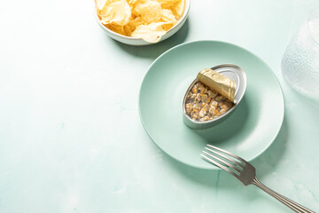 Canned cockles served on turquoise dish with copy space
