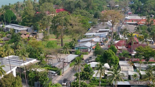 aerial footage of Kai Bae village a tourist hotspot on Koh Chang island, with roads, shops , hotel accommodation and roof tops