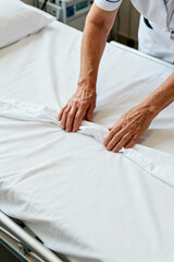 Fototapeta premium Healthcare Worker Making Hospital Bed White Linens Clean Sheets Medical Housekeeping Service