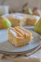Homemade pear pie on a white table with pears 