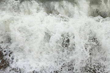 beautiful wave on sea at storm at cloudy day. close up. top view