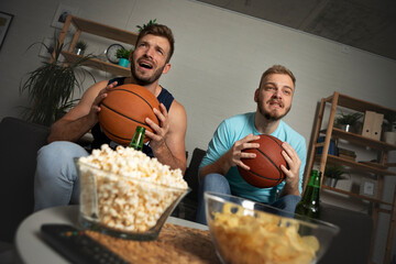 Friends cheering basketball game together