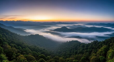 Panoramic Sunrise Over Misty Mountains and Lush Green Forest Landscape.