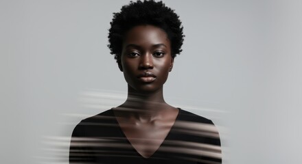 Fototapeta premium Serious young Black woman with natural curly hair looking at camera with motion blur effect