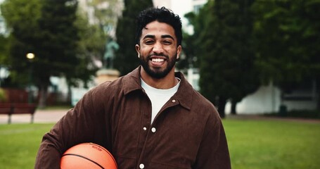 Happy, college or face of man with ball on campus for sports scholarship, education or learning. School, outdoor and basketball with student smile for study opportunity, athlete bursary or university - Powered by Adobe