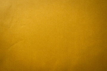 Brown paper texture background with soft lighting, ideal for minimal design, presentation template, poster layout, website background, or business stationery concept.