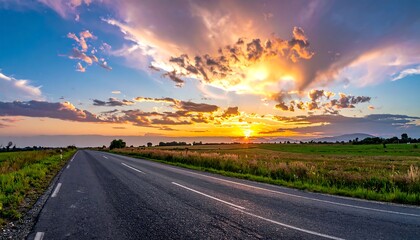 Asphalt road leading to a gorgeous sunset