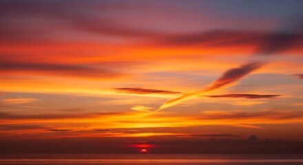 Fiery Sunset Over the Ocean - A Vivid Display of Natures Beauty.