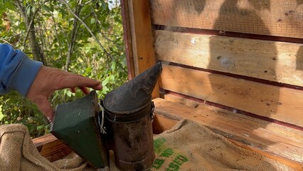 Metal bee smoker making smoke 
