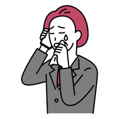 スマートフォンでの通話で泣く中年のスーツの女性