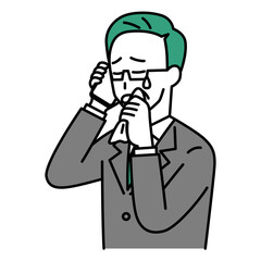 スマートフォンでの通話で泣く中年のスーツの男性