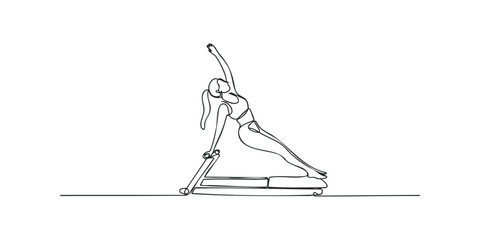 Woman performing pilates side bend exercise on reformer