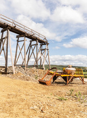 At Olav's Copper Mine, the Storwartz Mining Area features old wooden structures and mining machinery under a bright summer sky in R&oslash;ros Norway